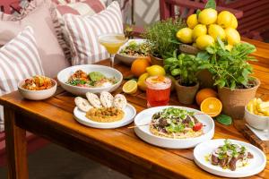 a wooden table with plates of food on it at Roslin Beach Hotel in Southend-on-Sea