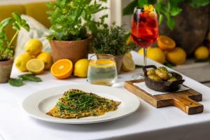 a table with a plate of pizza and a glass of wine at Roslin Beach Hotel in Southend-on-Sea