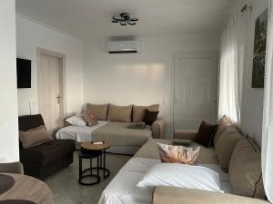 a living room with a couch and a table and a couch at Soleil House in Kallirakhi