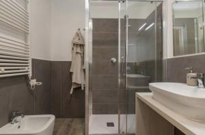 a bathroom with a shower and a sink and a toilet at I-Host Apartment - Gallura 11-2 in Milan