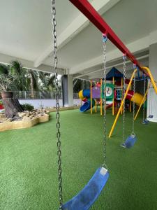 a playground with a slide and swings at Wake Up Above The City Lights in Sitiawan