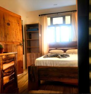 a bedroom with a bed with a window at Entre Vallee Eco lodge in Port Mathurin