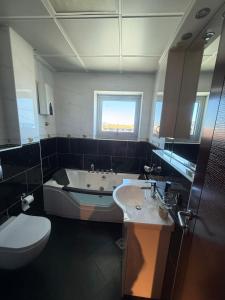 a bathroom with a tub and a sink and a toilet at Mia Bella in Bar +34 photos