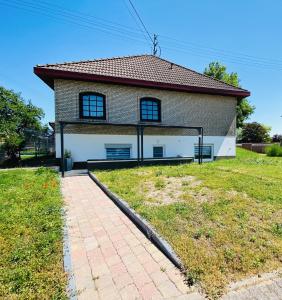 a house with a grassy yard in front of it at Ferienwohnung Elena 