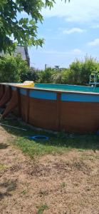 a large wooden boat sitting on the grass at Moonlight cottage with spa saumur in Courchamps
