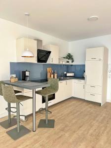 a kitchen with a table and chairs and a refrigerator at Wohlbefinden pur No 15 - Aurora Vista - ABC581 - nur Ferien in Hohen Wieschendorf