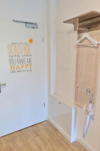 a laundry room with a sign on the wall at Wohlbefinden pur No 15 - Aurora Vista - ABC581 - nur Ferien in Hohen Wieschendorf +12 photos