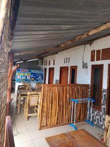 a room with a wooden fence and a table at Hendi Homestay in Gili Gede +31 photos