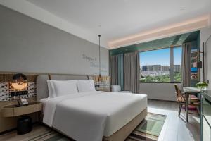 Postel nebo postele na pokoji v ubytování EVEN Hotel Yining