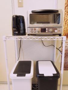 a microwave and a toaster oven on a shelf at Near Koiwa st 202 private Room in Tokyo