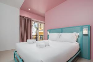 a bedroom with a large bed and a window at Boavista 83 Hostel Lisbon in Lisbon