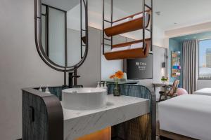 Postel nebo postele na pokoji v ubytování EVEN Hotel Yining