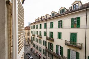 - une vue depuis la fenêtre d'un bâtiment avec volets verts dans l'établissement Vista sui tetti - 6 minuti da Porta Susa - WIFI, à Turin