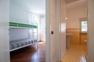 a room with a bunk bed and a bathroom at Tavaredo House in Polpenazze del Garda +39 photos