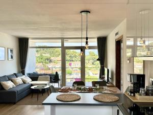 a living room with a couch and a table at Cala Morisca full AC Sea View Home in Tossa de Mar