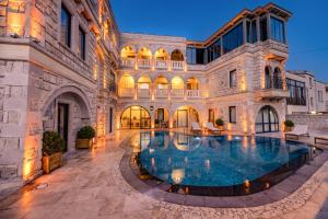 an estate with a swimming pool in front of a building at Soho Cappadocia in Göreme