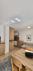 a room with a bed and a table and a couch at Mek lux Bjelasnica in Bjelašnica