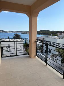 a balcony with a view of the water at Jurič in Rogoznica