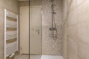 a bathroom with a shower with a glass door at Ferienwohnung Waldblick mit Terrasse und Garten - familienfreundlich in Heringhausen +18 photos