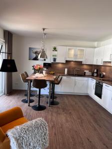 a kitchen with a table and a dining room at Ferienhaus Diemelblick 39 mit Hund - direkt am Diemelsee mit Sauna, Terrasse und Garten für bis zu 5 Personen in Diemelsee
