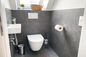 a small bathroom with a toilet and a sink at Ferienwohnung Alter Stall - rechte Seite für 3 Personen in Ohne +9 photos