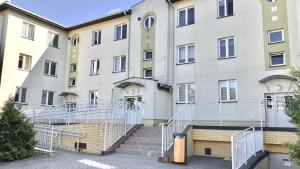 a building with stairs in front of it at Apartament na Saperskiej in Płock