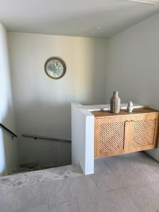 a room with a counter and a clock on the wall at Oleander Evia in Áyioi Apóstoloi