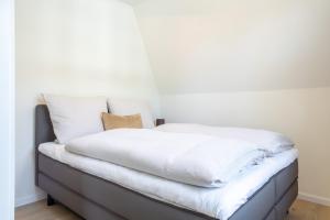 Postel nebo postele na pokoji v ubytování Villa Dornkamp 4 - Luxuriöse Ferienwohnung für 4 Personen inklusive Balkon und Sauna