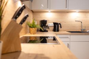 a kitchen with a sink and a coffee maker at Dorumer Seestern - Ferienwohnung mit Terrasse und Sauna in Dorum