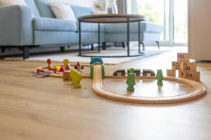 a wooden toy track on the floor in a living room at Dorumer Seestern - Ferienwohnung mit Terrasse und Sauna in Dorum +15 photos