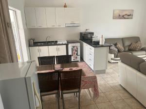 a kitchen and living room with a table and chairs at Casa Ida 2 Tarrafal, Santiago, Cape verde in Tarrafal