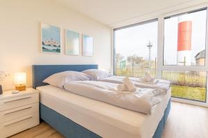 Ένα ή περισσότερα κρεβάτια σε δωμάτιο στο Exklusive Ferienwohnung BeltStrand mit 2 Schlafzimmern und Garten