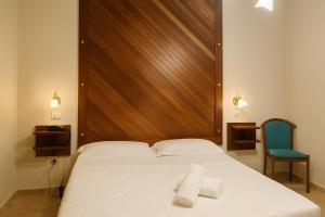 Letto o letti in una camera di Albergo Reale