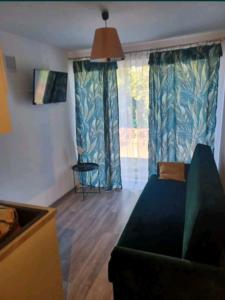a living room with a couch and a window at Pokój u Julii in Okuninka