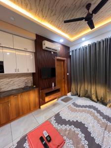 a large living room with a television and a bed at Atha luxury studio 02 in Jāmb