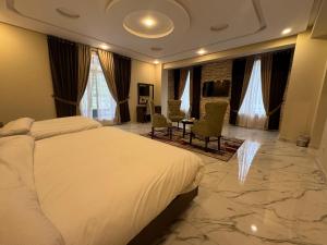 a hotel room with a bed and a table and chairs at Riviera Resort in Naran