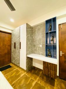 a bathroom with a shower and a shelf with shoes at luxury Jaipur Jewel near airport by Akira Homes in Jaipur