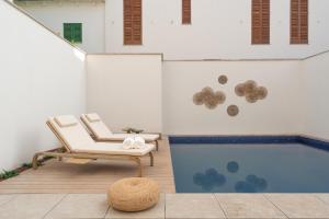 a white chair and a stool in a room at Casa Playa in Palma de Mallorca