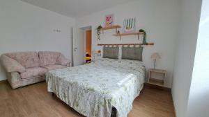 a bedroom with a bed and a couch at Apartment in Somaggia - CasaCamillo in Riva