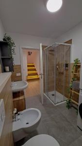 a bathroom with a toilet and a shower and a sink at Apartment in Somaggia - CasaCamillo in Riva +44 photos