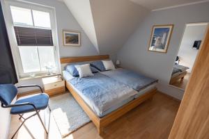 a bedroom with a bed and a large window at Ostseetraum, Whg 4 in Zingst