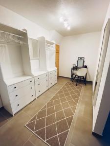 a room with white cabinets and a chair in it at Ferienwohnung Elena 