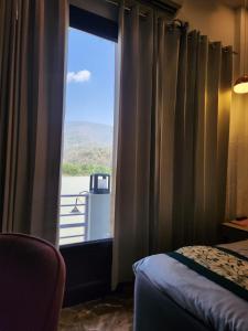 Ένα ή περισσότερα κρεβάτια σε δωμάτιο στο Ganga Riverfront Rishikesh +7 φωτογραφίες