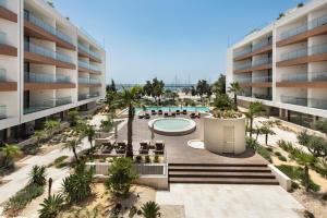 an aerial view of an apartment complex with a swimming pool at Del Mar Apartment - BT in Olhão