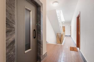 a hallway with a door and a tile floor at Terrazzo del gelsomino in Rapallo +20 photos