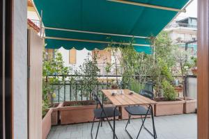 a table and chairs on a balcony with plants at Terrazzo del gelsomino in Rapallo