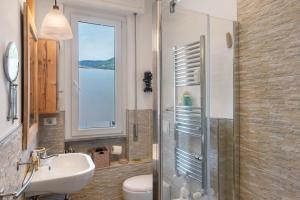 a bathroom with a sink and a shower with a window at Terrazzo del gelsomino in Rapallo +20 photos