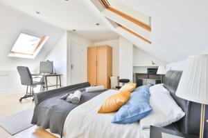 a bedroom with a large bed with blue pillows at The Wishing Well- Lovely Spacious Home In BS4 Sleeps 8 By STAE- Homes in Bristol