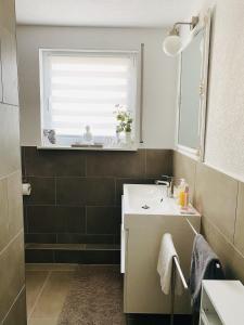 a bathroom with a sink and a window at Ferienwohnung Elena  +7 photos