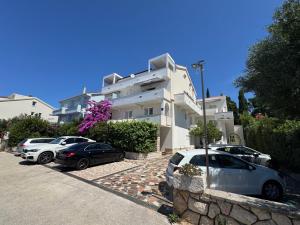 a group of cars parked in front of a building at Emanuela 2 in Novalja